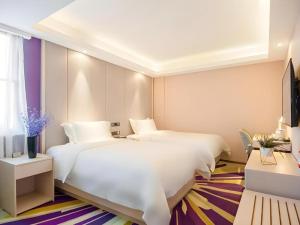 a hotel room with two beds and a window at Lavande Hotel Beijing Fangshan Changyang Metro Station in Beijing +267 photos