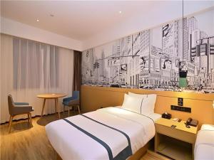 a hotel room with a bed and a wall mural at City Comfort Inn Kunming High-speed Railway South Station 7th Street Area in Kunming +161 photos