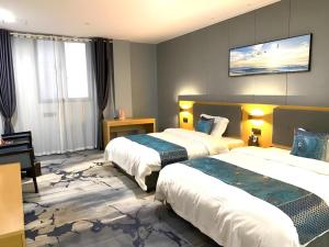 a hotel room with two beds and a piano at Shell Hotel Luzhou Longmatan District Dujia Street Riverside in Luzhou +3 photos