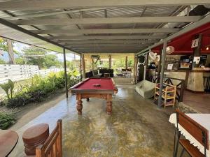 a room with a pool table in the middle of it at Butterfly Resort Hostel, Pai in Pai