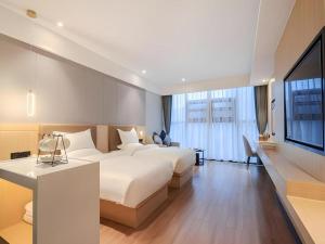 Postel nebo postele na pokoji v ubytování Gya Hotel Chengdu Global Center Jinchenghu Metro Station + 263 fotografií