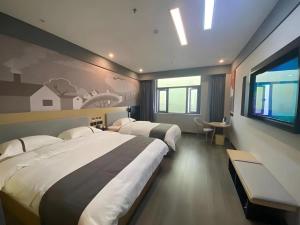 a hotel room with two beds and a window at Thank Inn Jiangxi Nanchang Anyi County Fenghuangshan Industrial Park in Nanchang