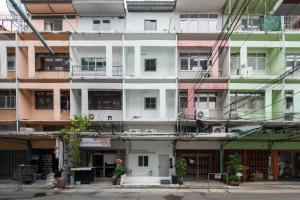 a tall white building with lots of windows at Bangkok Group Haven - 6BR Bangchak BTS 12 sleeps RB4 in Amphoe Phra Khanong