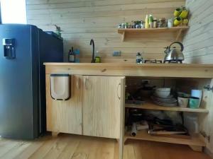 a kitchen with a wooden counter and a refrigerator at Tiny House de Madera con Vista Panoramica in Guasca