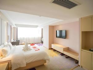 a bedroom with a white bed and a television at Lavande Hotel Wuhan Jianghan Road Jiqing Street in Wuhan +95 photos