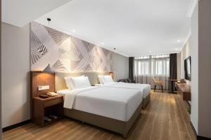 Ένα ή περισσότερα κρεβάτια σε δωμάτιο στο Borrman Hotel Chongqing Hechuan High-speed Railway Station District Government +230 φωτογραφίες