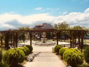 a pergola with a fountain in a park at Sea view apartment in Tsarevo