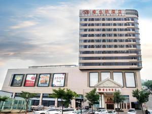 a large building with a sign on top of it at Vienna Hotel Hebei Tangshan Nanhu Park in Tangshan