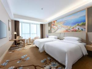 Ένα ή περισσότερα κρεβάτια σε δωμάτιο στο Vienna Hotel Jiangxi Chongren Bus Station +181 φωτογραφίες