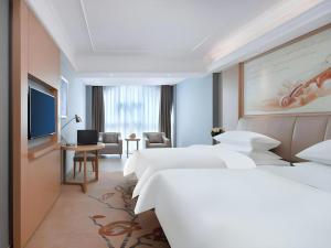 a hotel room with two beds and a television at Vienna Hotel Anhui Xuancheng Langxi in Langxi +91 photos