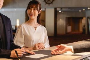 a woman and a man sitting at a table with their hands at Hotel Mariners Court Tokyo in Tokyo +40 photos