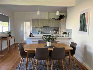 a kitchen and dining room with a table and chairs at Mildura Park Views in Mildura