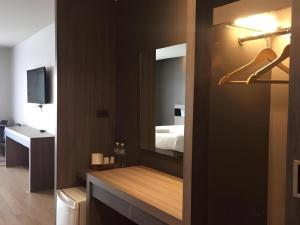 a bathroom with a sink and a mirror at Melodi Hotel Dannok in Sadao +28 photos