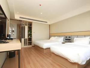 a hotel room with two beds and a desk at Green Tree Inn Yecheng County Zero Kilometer in Yecheng +56 photos