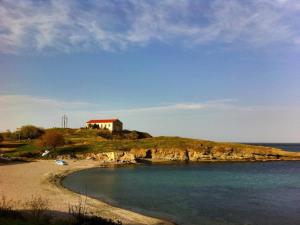 a small house on a small island in the water at Sea view apartment in Tsarevo +4 photos