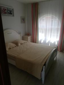 a bedroom with a large bed with a window at Sea view apartment in Tsarevo