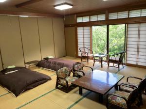 a room with two beds and a table and chairs at HOTEL LT Kitchen Yugawara in Yugawara +179 photos