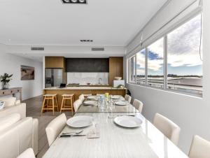 a dining room and kitchen with a table and chairs at Ocean View Penthouse 1328 at Bells Boulevard in Kingscliff