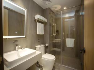 a bathroom with a toilet and a sink and a shower at GreenTree Inn Express Hefei City Bus Station in Feicheng +79 photos