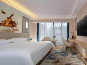 Postel nebo postele na pokoji v ubytování Vienna Hotel Chengdu Xinjin Old Pier Liujianian Metro Station + 71 fotografií