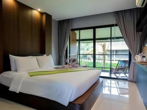 a bedroom with a large bed and a large window at The Breeze Lipe Resort in Ko Lipe +211 photos