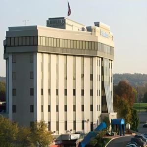 a large white building with a flag on top of it at Valley Forge Casino Resort in King of Prussia