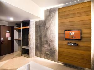 a tv on a wall in a room at B2 Thippanate Boutique & Budget Hotel in Chiang Mai