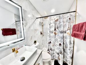 a bathroom with a sink and a toilet and a shower curtain at Xlnc Exotic home13824 Powers Rd in Poway +40 photos