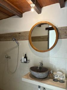 a bathroom with a sink and a mirror at Kubu Shanti Sanda in Munduk