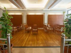 a dining room with wooden tables and chairs at Grand Plaza Hotel in Hat Yai +119 photos