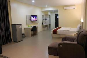 a hotel room with a bed and a tv at Balai View Hotel in Tanjung Balai Karimun