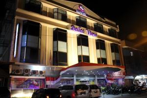 a building with cars parked in front of it at Balai View Hotel in Tanjung Balai Karimun
