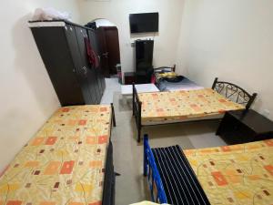 Letto o letti in una camera di سكن شباب بالتعاون - ALEX Hostel - Sharjah