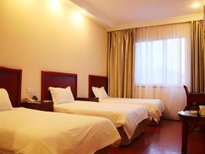 a hotel room with two beds and a window at GreenTree Inn Jiangsu Suzhou Shi Road North Tongjing Road Subway Station Express Hotel in Suzhou +148 photos