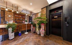 a restaurant with potted plants in a lobby at Daejeon Namoo Hotel in Daejeon