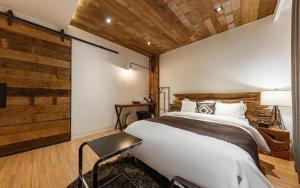 a bedroom with a large white bed and wooden walls at Daejeon Namoo Hotel in Daejeon +193 photos