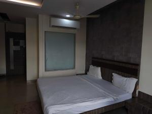 a bedroom with a large bed with a window at Collection O Aurangabad Central Bus Terminal in Aurangabad