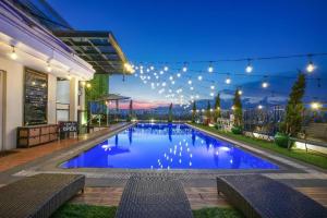 a large swimming pool with lights on it at night at Lafayette Boutique Hotel in Yogyakarta
