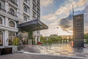 a large building with a sign in front of it at Lafayette Boutique Hotel in Yogyakarta