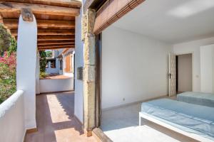 a bedroom in a villa with a bed and a balcony at Pescadors in Pals
