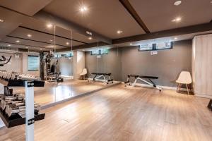 a gym with several treadmills and exercise machines at Palm Spring Condo Nimman - Deluxe 810 in Chiang Mai