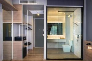 a bathroom with a shower and a toilet in it at R Photo Hotel in Nakhon Phanom +139 photos