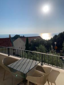 a table and chairs on a balcony with a view at REZEVICI BOUTIQUE VILLA in Petrovac na Moru