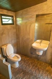 a bathroom with a toilet and a sink at Phuphayot Resort in Huai Yot