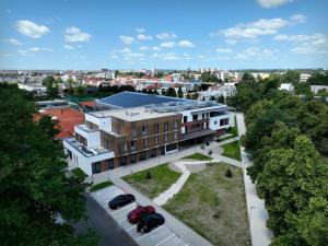a building with two cars parked in front of it at Hotel Break Hradec Králové in Hradec Králové