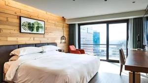 a bedroom with a white bed and a desk and a window at Walkerhill Douglas House (Adults Only) in Seoul +102 photos