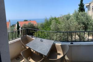 a balcony with a table and chairs on a balcony at REZEVICI BOUTIQUE VILLA in Petrovac na Moru