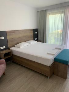 a bedroom with a large bed and a window at REZEVICI BOUTIQUE VILLA in Petrovac na Moru
