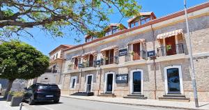 a car parked in front of a brick building at Hice Room Lungomare Fronte Mare in Catanzaro