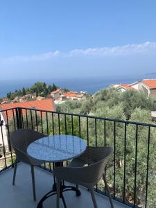 a table and chairs on a balcony with the ocean at REZEVICI BOUTIQUE VILLA in Petrovac na Moru